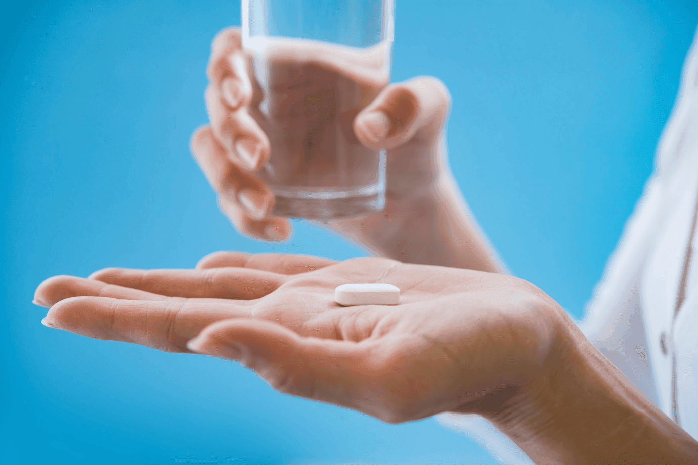woman-s-hand-pours-medicine-pills-out-bottle